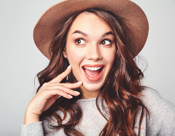 Portrait of young stylish laughing girl model in gray casual summer clothes in brown hat with natural makeup isolated on gray background. Looking at camera - Fotografie, Obrázek