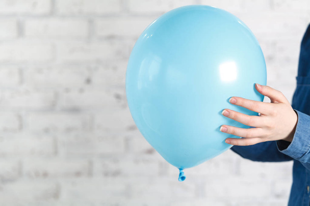 Blue balloon in female hands - Фото, изображение