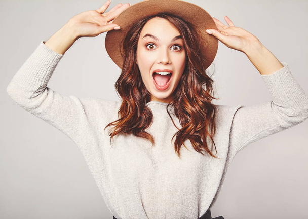 Portrait of young stylish  girl model excited screaming shocked in gray casual summer clothes in brown hat with natural makeup isolated on gray background. Looking at camera - Fotografie, Obrázek