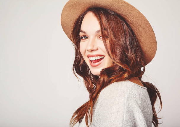 Portrait of young stylish laughing girl model in gray casual summer clothes in brown hat with natural makeup isolated on gray background. Looking at camera - Foto, Imagen
