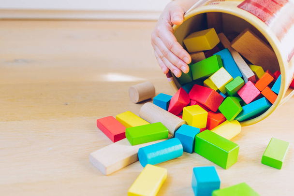 child playing with colorful wooden blocks - Fotó, kép