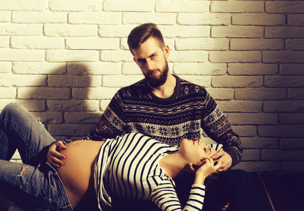 bearded man and pretty pregnant woman with round belly - Foto, Imagen