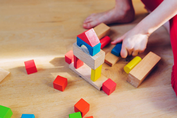 child playing with colorful wooden blocks  - Fotó, kép