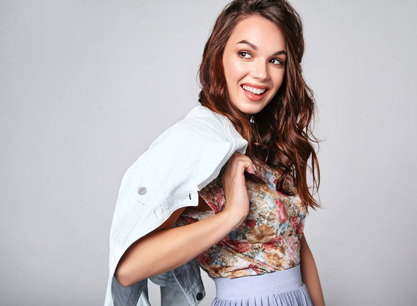 Portrait of young stylish laughing girl model in colorful casual summer clothes with natural makeup isolated on gray background. Looking at camera - Zdjęcie, obraz
