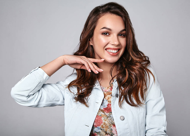 Portrait of young stylish laughing girl model in colorful casual summer clothes with natural makeup isolated on gray background. Looking at camera - Fotó, kép
