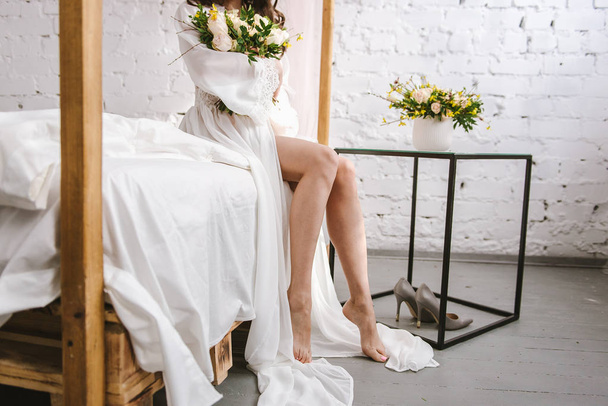 Close-up of a bride peignoir. Morning of the bride. Bride's fees. Underwear. Bed. - Фото, изображение