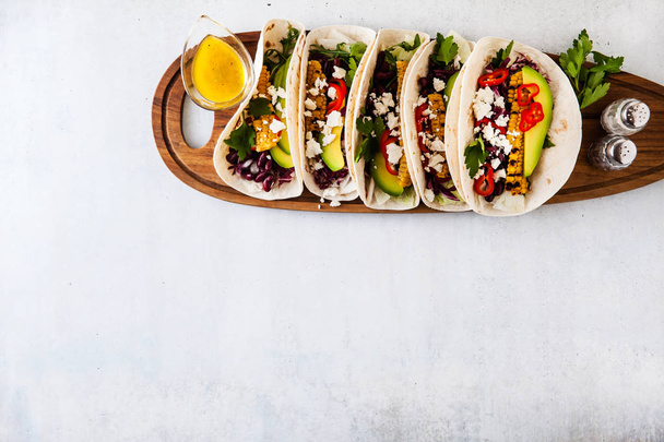 Vegetarian snack tacos with grilled vegetables, avocado, feta ch - Photo, Image