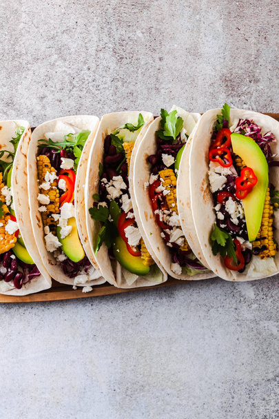 Mexican tacos with avocado, grilled corn, red cabbage slaw and c - Фото, изображение