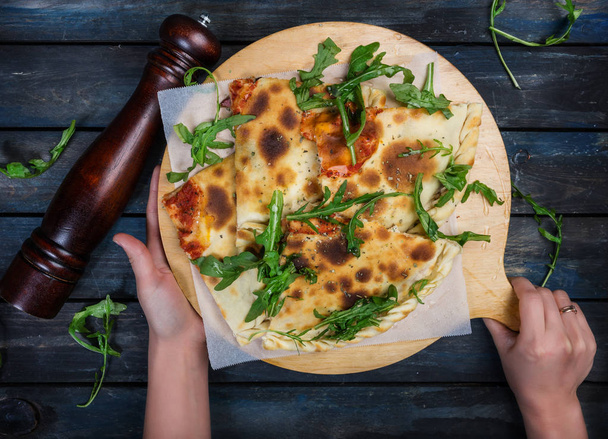 Calzone - Stuffed Pizza with ham, mushrooms, arugula and cheese. - Фото, зображення