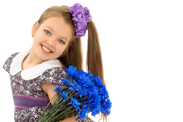 Little girl with a bouquet of flowers - Fotografie, Obrázek