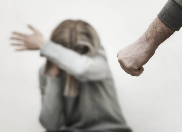 Man beating up his wife illustrating domestic violence - 写真・画像