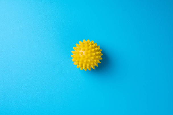 Špičaté masážní míč na modrém pozadí pohledu shora. Vlastní masáž, zdravé, wellness a reflexní terapie koncept - Fotografie, Obrázek