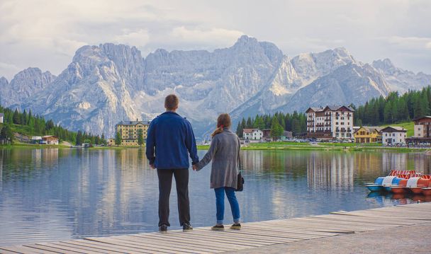 couple of man and woman at Misurina lake in Dolomites mountain l - Fotoğraf, Görsel
