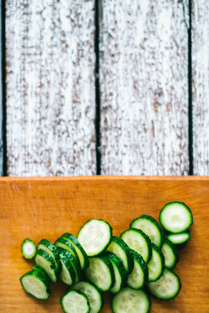 Sliced cucumbers on a wooden background. The concept of a healthy diet - Valokuva, kuva