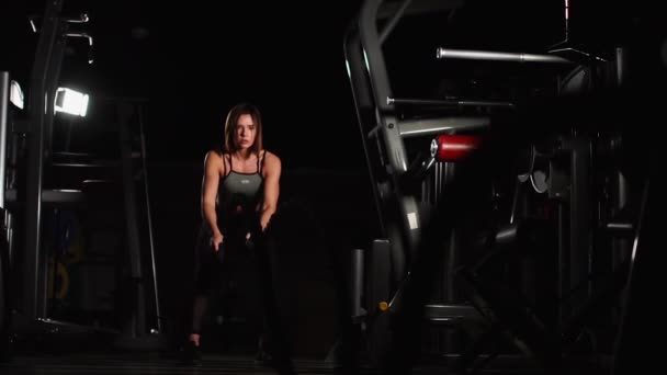 Female athlete working out with heavy ropes at the gym. - Footage, Video