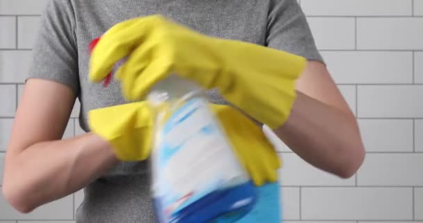Mujer brazos cruzados en guantes una esponja y spray
 - Imágenes, Vídeo