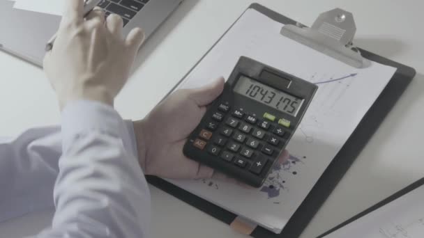 Above view of Healthcare costs and fees concept.Hand of smart doctor used a calculator for medical costs in modern hospital in slow motion - Footage, Video