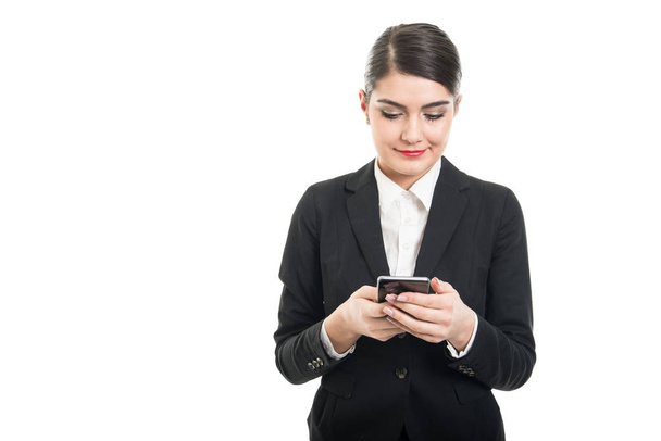 Beautiful stewardess browsing or texting on smartphone - Foto, imagen
