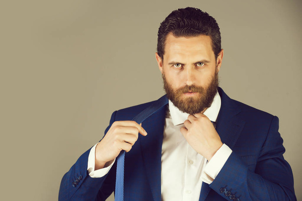 portrait of handsome serious business man on grey background - Foto, afbeelding