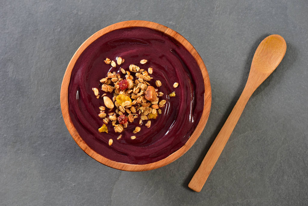 Frozen acai and granola on rustic bowl - Photo, Image