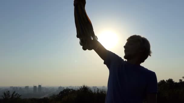 Cheery man raises many medals at sunset in summer in slo-mo - Footage, Video