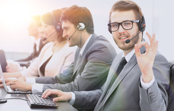 customer service representative with headset showing sign "OK" - Foto, Imagen