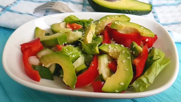 salad with avocado and sesame, sprinkle, on a wooden, - Footage, Video