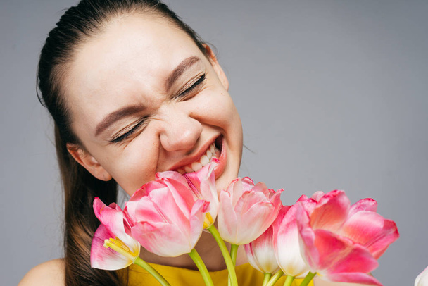 happy beautiful woman holding flowers, tulips, mother's day - Photo, image