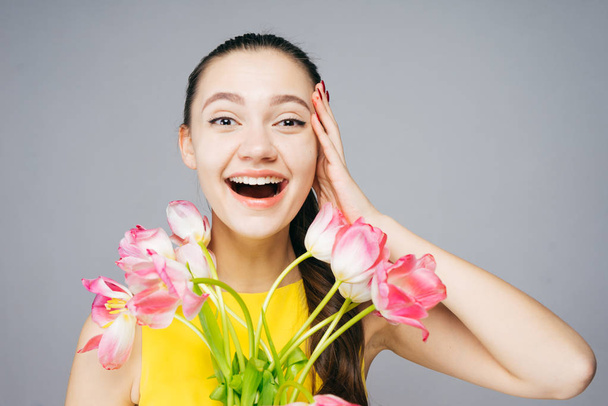 happy woman holding flowers, tulips, mother's day - Фото, изображение
