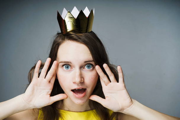 amazed woman with a crown on her head - Fotó, kép