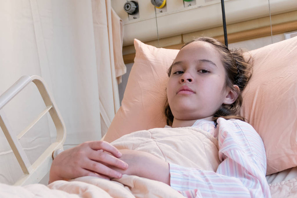 Young tween girl in hospital bed - Photo, Image