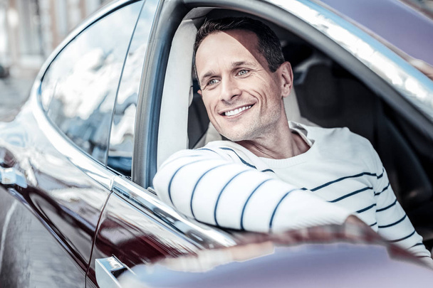 Happy delighted man sitting in his car - Fotografie, Obrázek