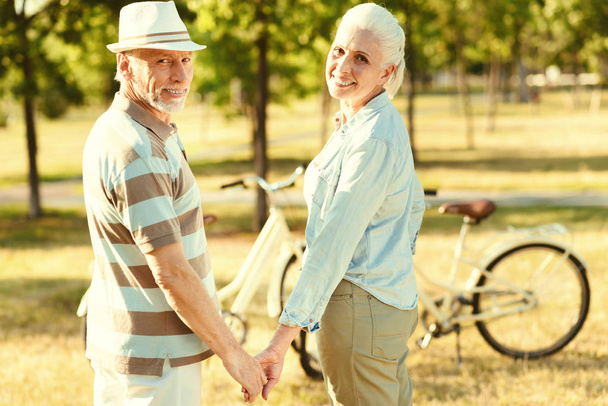 Happy aged couple holding hands - 写真・画像