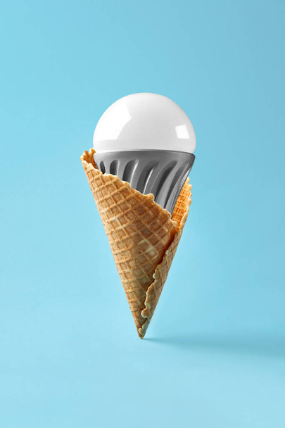 Led lamp in ice cream cone, innovation concept - Foto, afbeelding
