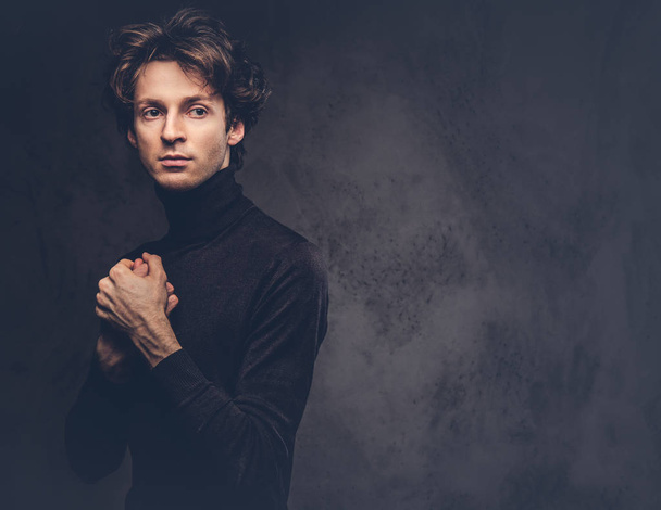Portrait of a charismatic sensual male in black sweater. Creative personality. - Photo, image