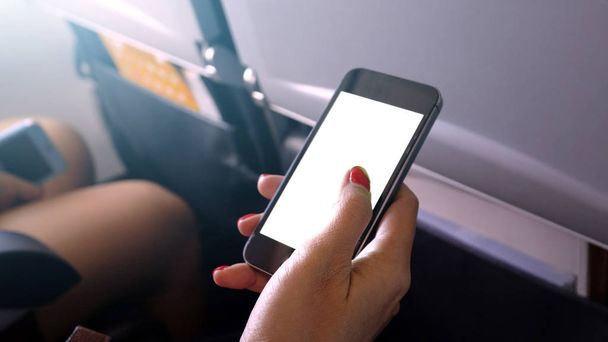 touching and slide mobile phone screen on airplane or aircraft,b - Photo, image