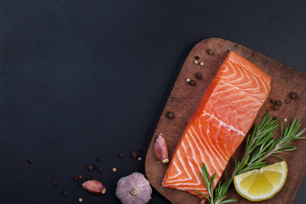salmon and spices on a wooden cutting board - Foto, immagini