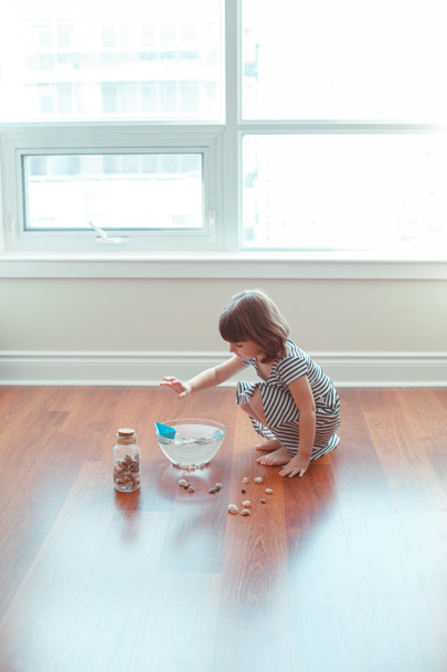 Ritratto di simpatica bambina caucasica bianca in età prescolare che gioca con navi di carta e acqua in casa. Sviluppo precoce della creatività, attività dei bambini. Sogni di avventura concetto di viaggio
 - Foto, immagini
