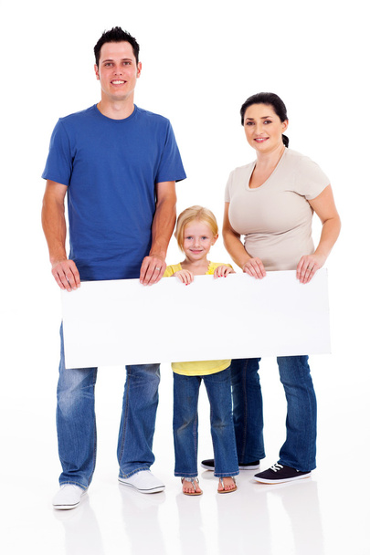 Happy young family with banner on white background - Φωτογραφία, εικόνα