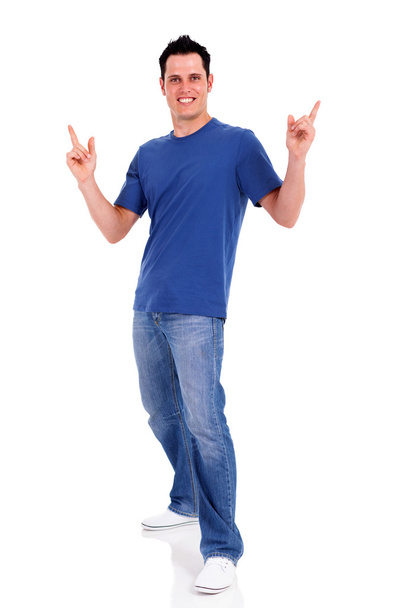 Casual young man pointing on white background - Valokuva, kuva