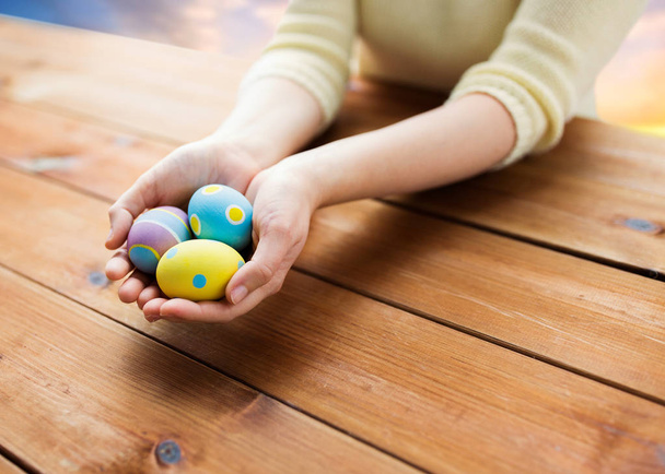 close up of woman hands with colored easter eggs - Photo, image