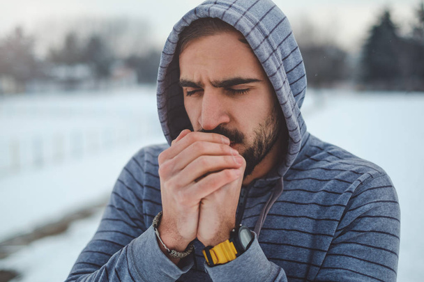 Man warming hands with his breath and preparing to train - Photo, Image