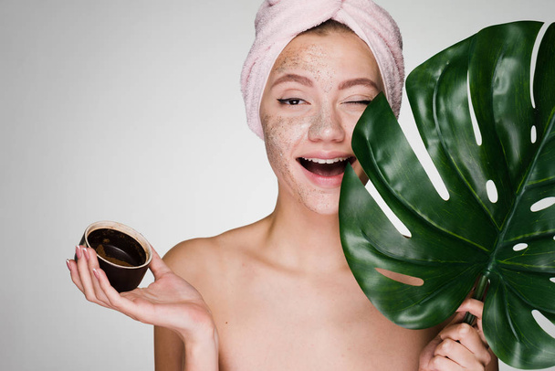happy woman has applied a scrub to the skin after a shower - Foto, afbeelding
