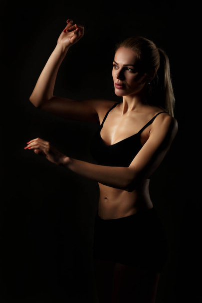 sport blonde woman on black background - Photo, Image