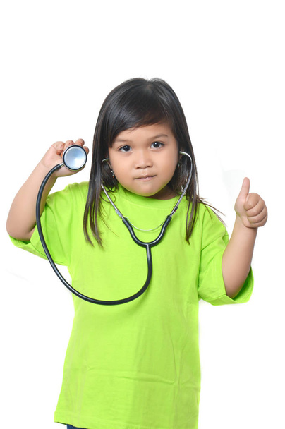 asian little girl dressed in green with a stethoscope - Photo, Image