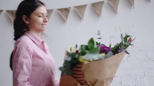 Florist inspects a bouquet of different flowers - Záběry, video