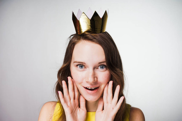 amazed woman with crown on her head posing on camera - Photo, Image