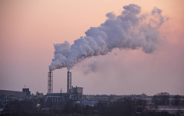 Chimney smoking stack. Air pollution and climate change theme. Poor environment in the city. Environmental disaster. Harmful emissions into the environment. Smoke and smog. - Photo, Image