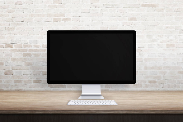 Local de trabalho limpo com visor de computador. Tela em branco para promoção de web site. Mesa vazia e parede de tijolo
. - Foto, Imagem