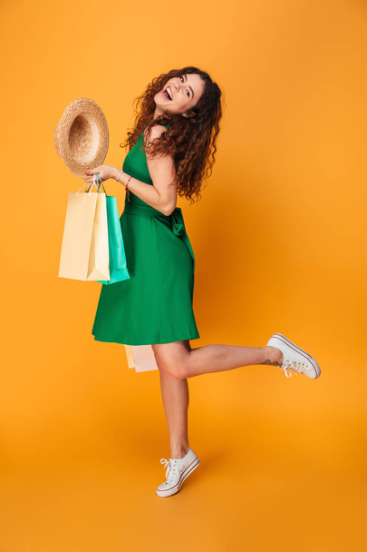 Happy young woman holding shopping bags. - Foto, Bild